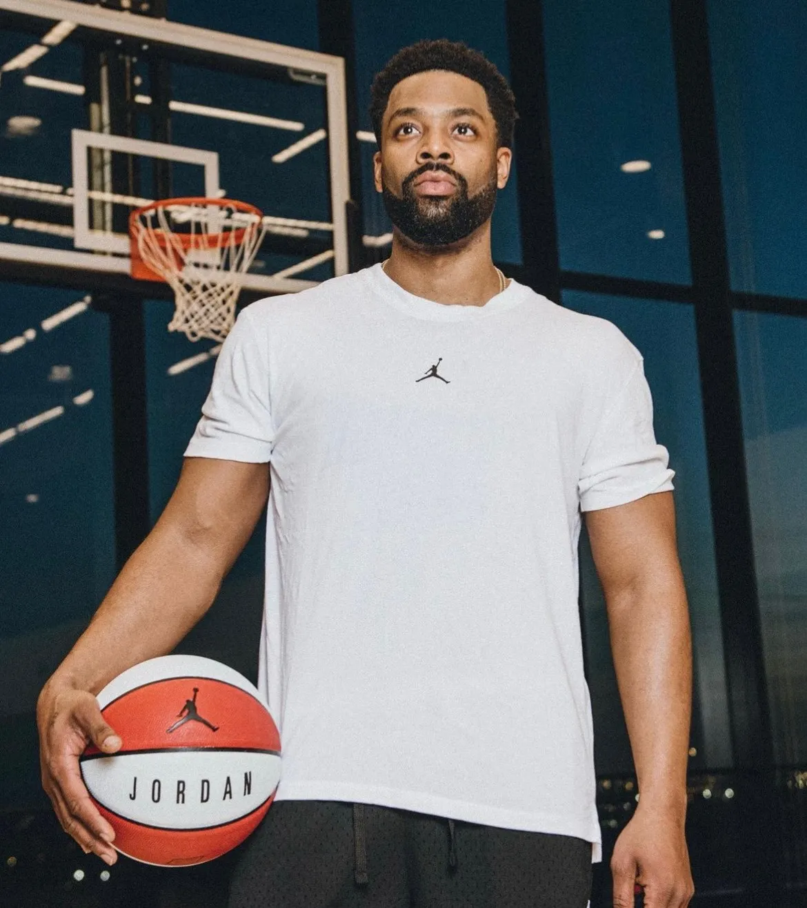LaRoyce holding a basketball on an indoor court